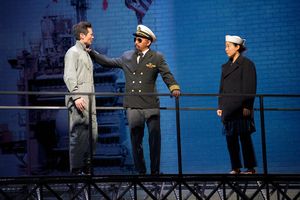 Quang (James Seol, left) is informed by Captain Chambers (Jomar Tagatac, center) of t Photo